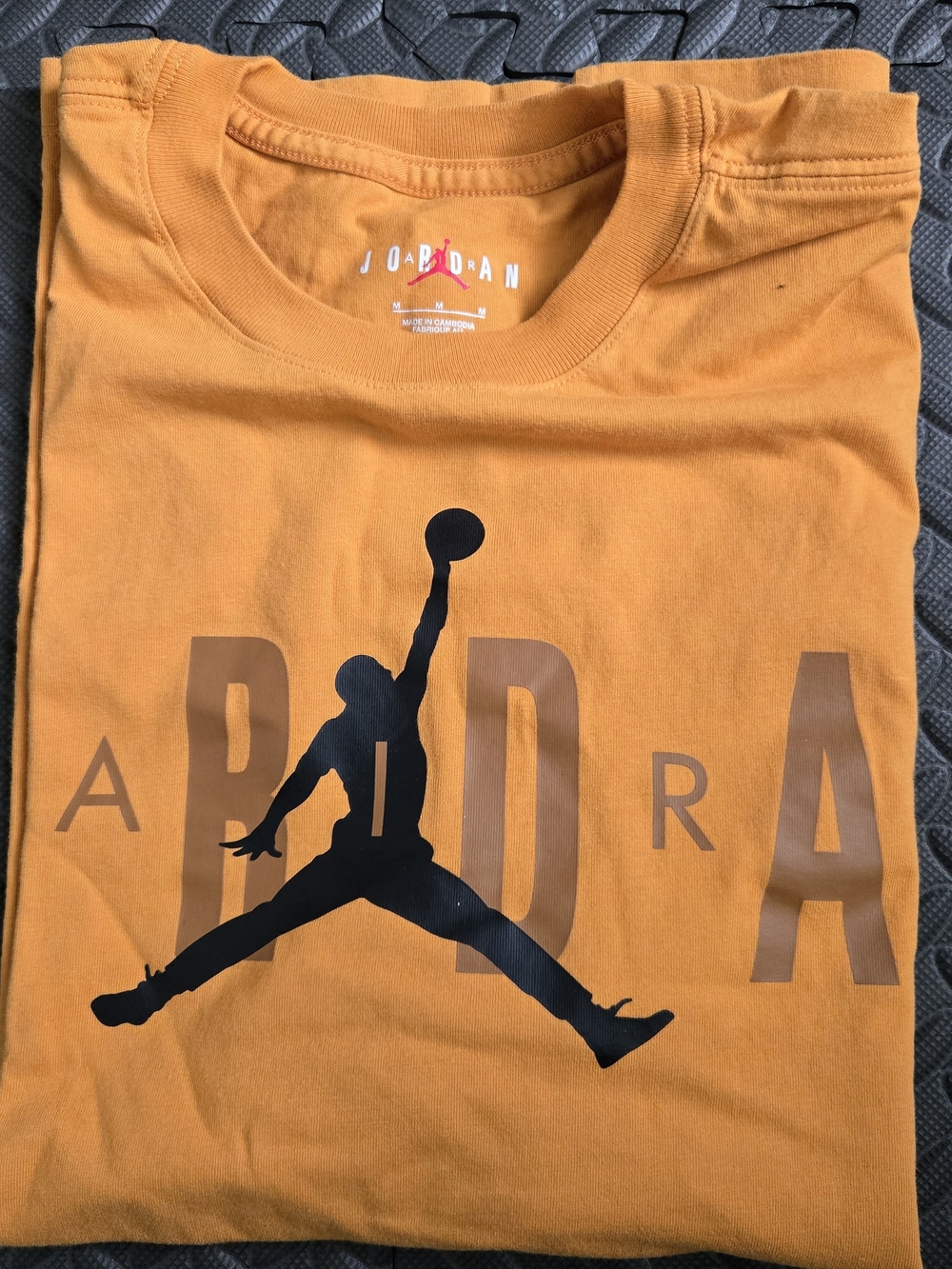 Jordan Men’s Orange T-Shirt with Black Jumpman Graphic